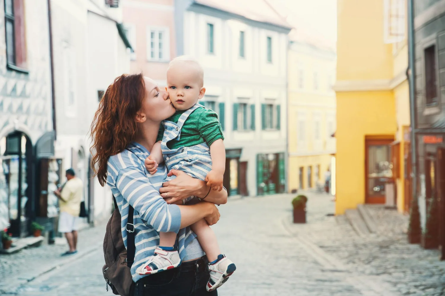 Mulher com filho no colo feliz por ter cidadania italiana via materna