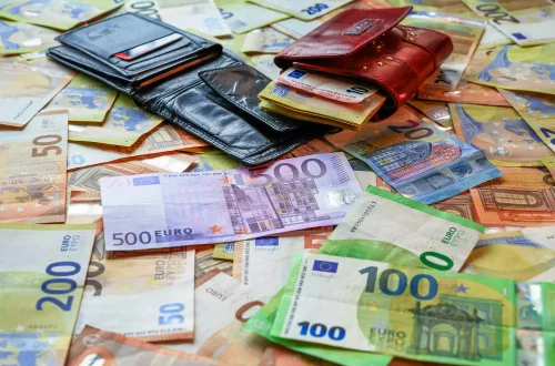 Multas na cidadania italiana: Foto de carteiras em cima de notas de euro