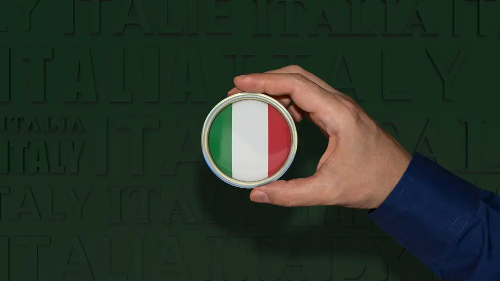 lente de aumento com a bandeira italiana demonstrando o serviço de tradução juramentada para cidadania italiana